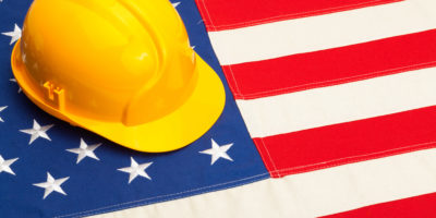 construction hard hat on American flag - SDVOSB